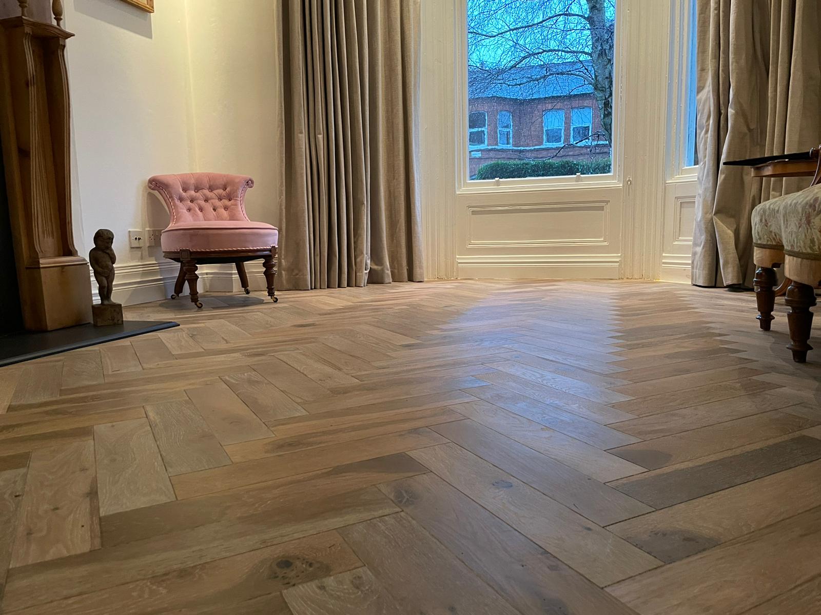 Herringbone flooring installation in progress